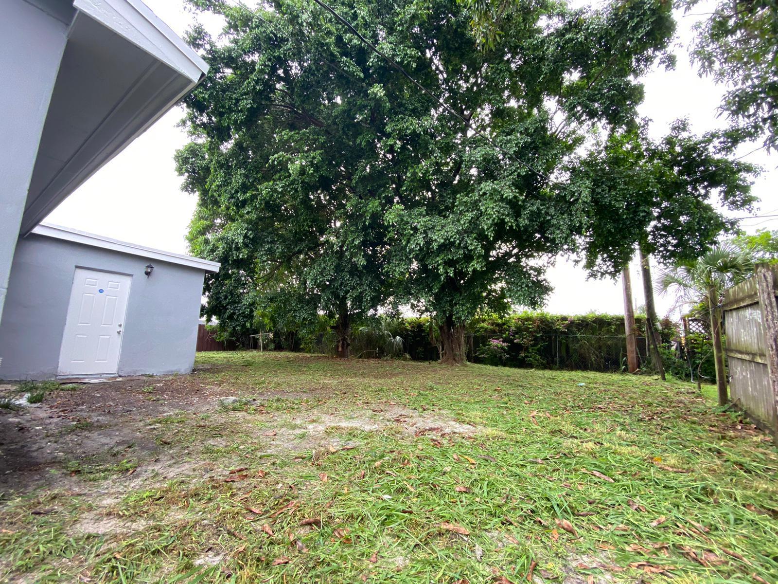 811 Southwest 12th Court Deerfield Beach, FL 33441 - Photo 15 of 16 a view of a backyard with a tree