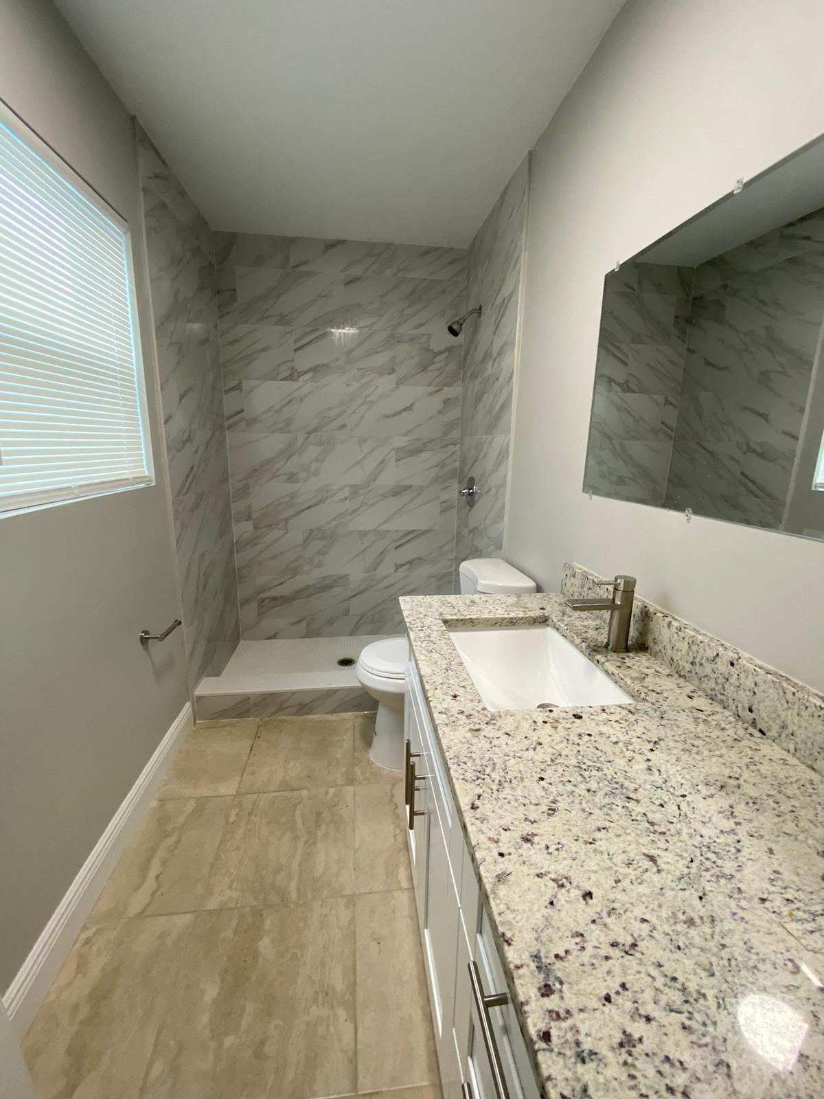 811 Southwest 12th Court Deerfield Beach, FL 33441 - Photo 4 of 16 a bathroom with a sink and a mirror