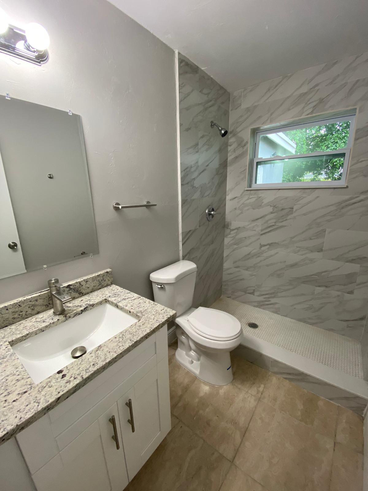 811 Southwest 12th Court Deerfield Beach, FL 33441 - Photo 6 of 16 a bathroom with a granite countertop sink toilet and shower
