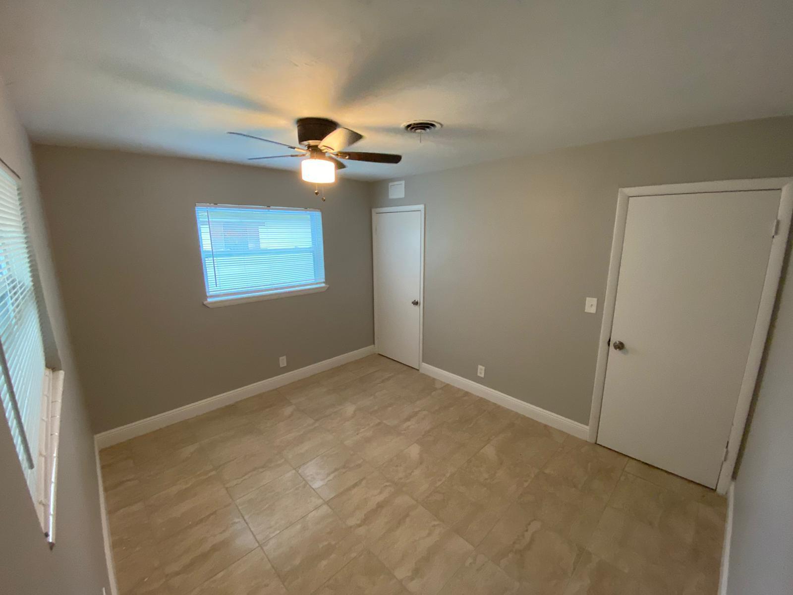 811 Southwest 12th Court Deerfield Beach, FL 33441 - Photo 8 of 16 an empty room with windows and fan