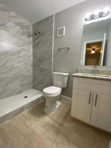 a bathroom with a toilet sink and shower