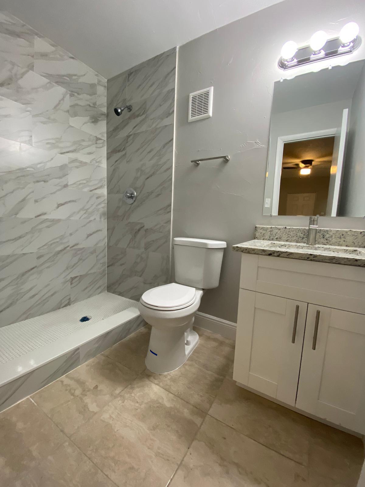 811 Southwest 12th Court Deerfield Beach, FL 33441 - Photo 9 of 16 a bathroom with a toilet sink and shower