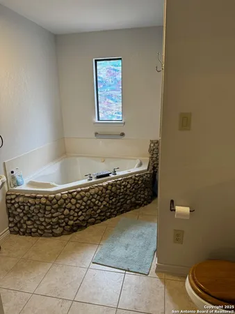 a bathroom with a bathtub and toilet