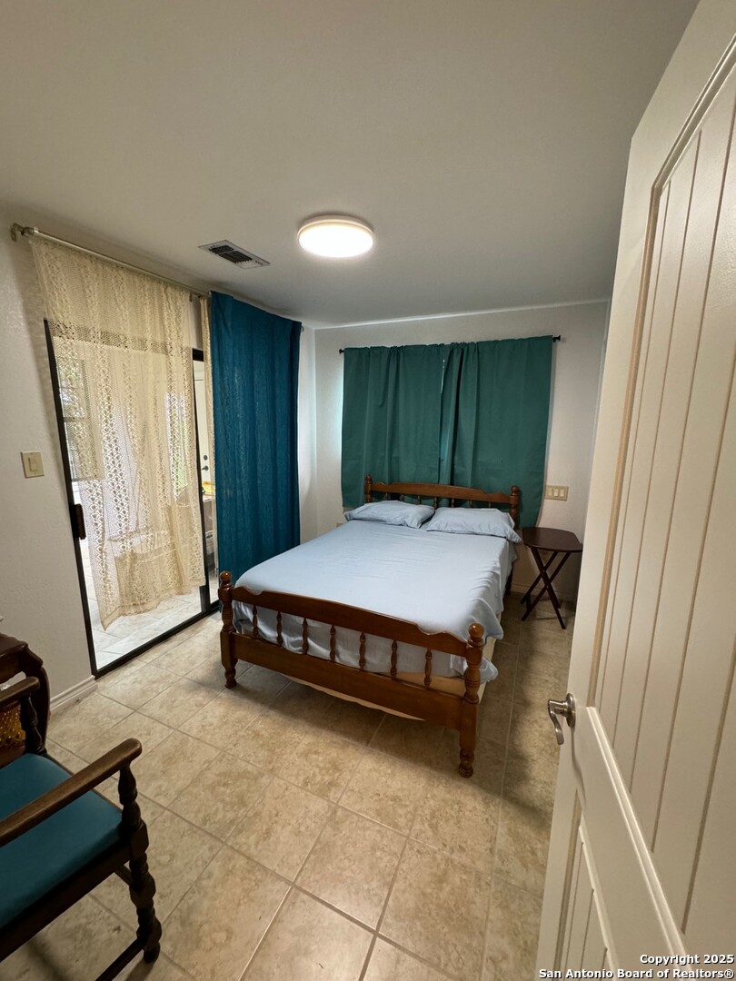 572 Fm 2107 Medina, TX 78055 - Photo 10 of 15 a bed sitting in a room next to a window