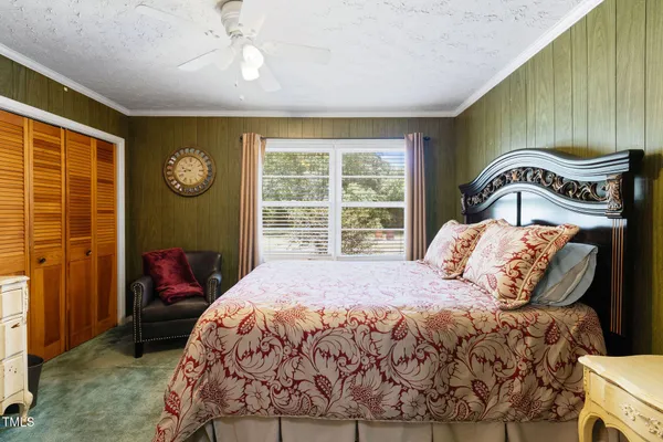 a bedroom with a large bed and a window