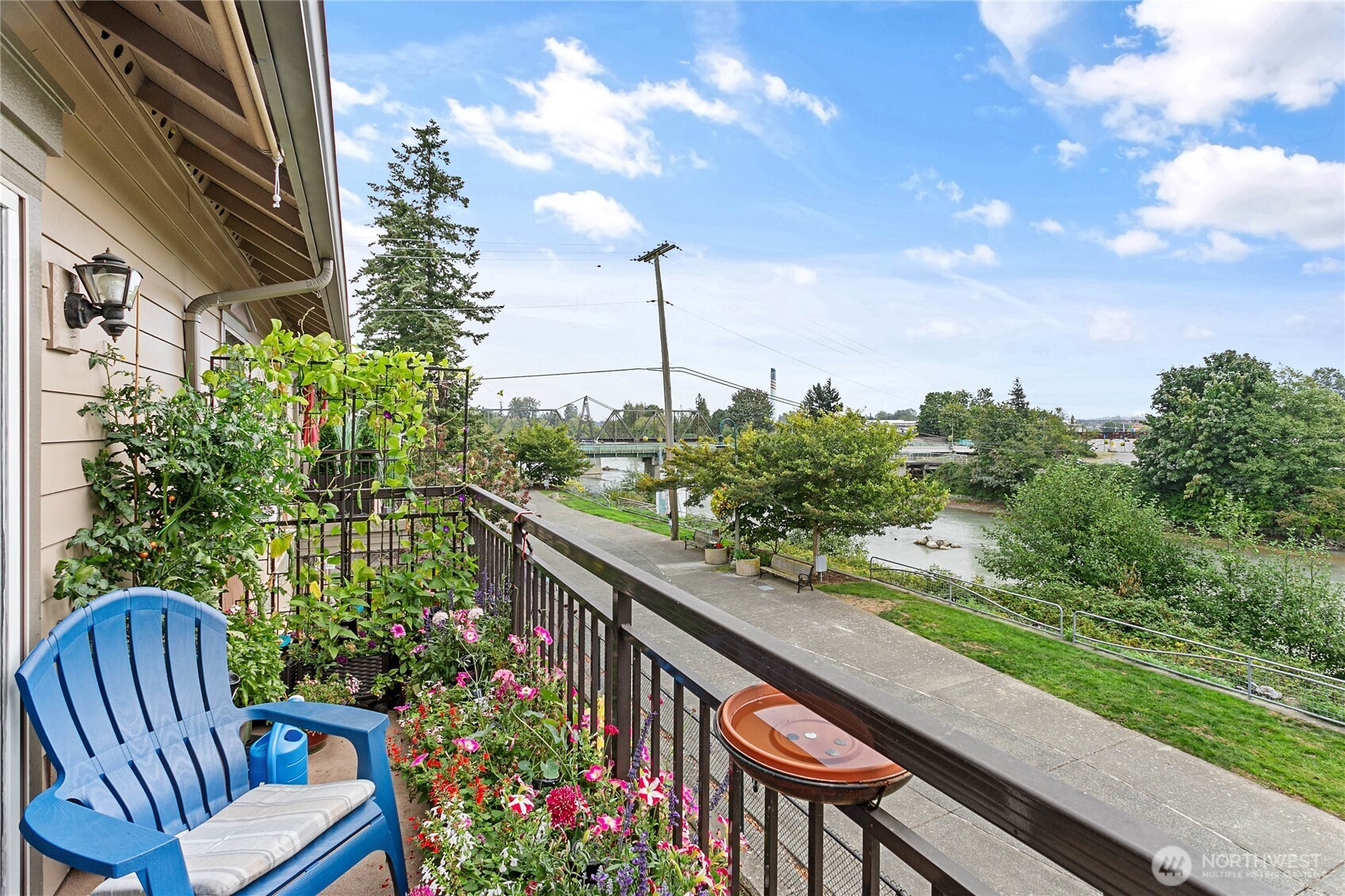 1991 Alder Street, Unit 204 Ferndale, WA 98248 - Photo 25 of 27 a balcony with wooden floor and outdoor seating