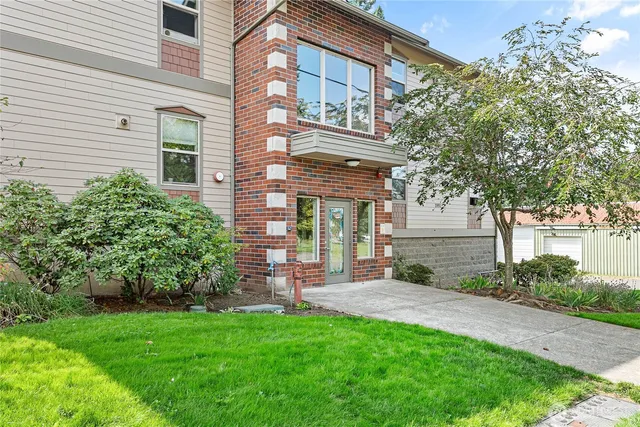 a view of a brick building next to a yard