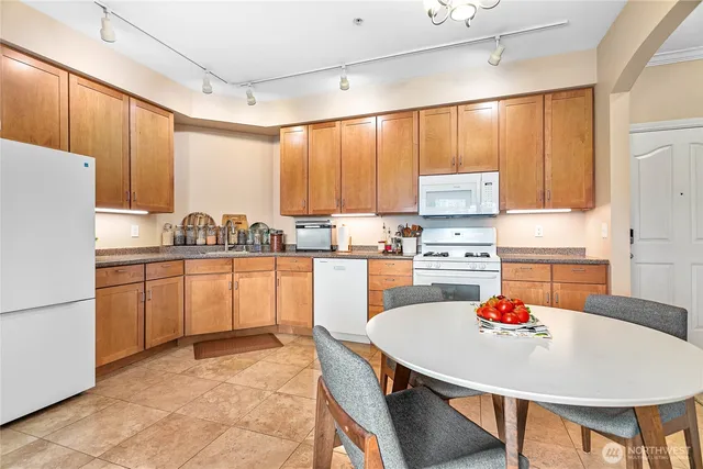 a kitchen with refrigerator and white cabinets