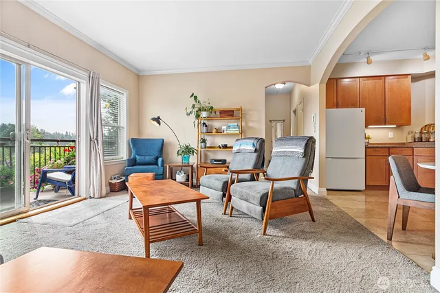 a dining room with furniture and a floor to ceiling window