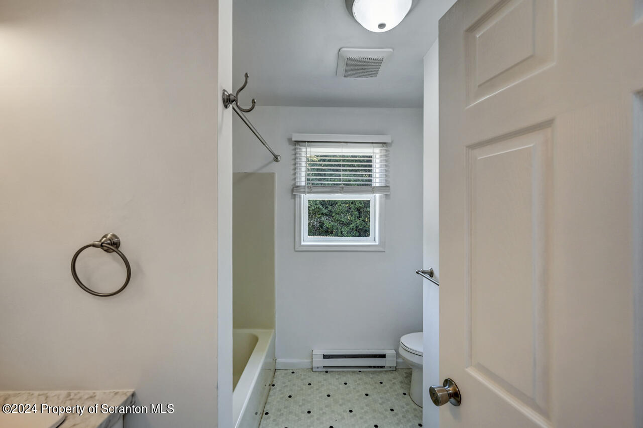 104 Bowens Road Moscow, PA 18444 - Photo 20 of 48 a bathroom with a window a toilet and a shower