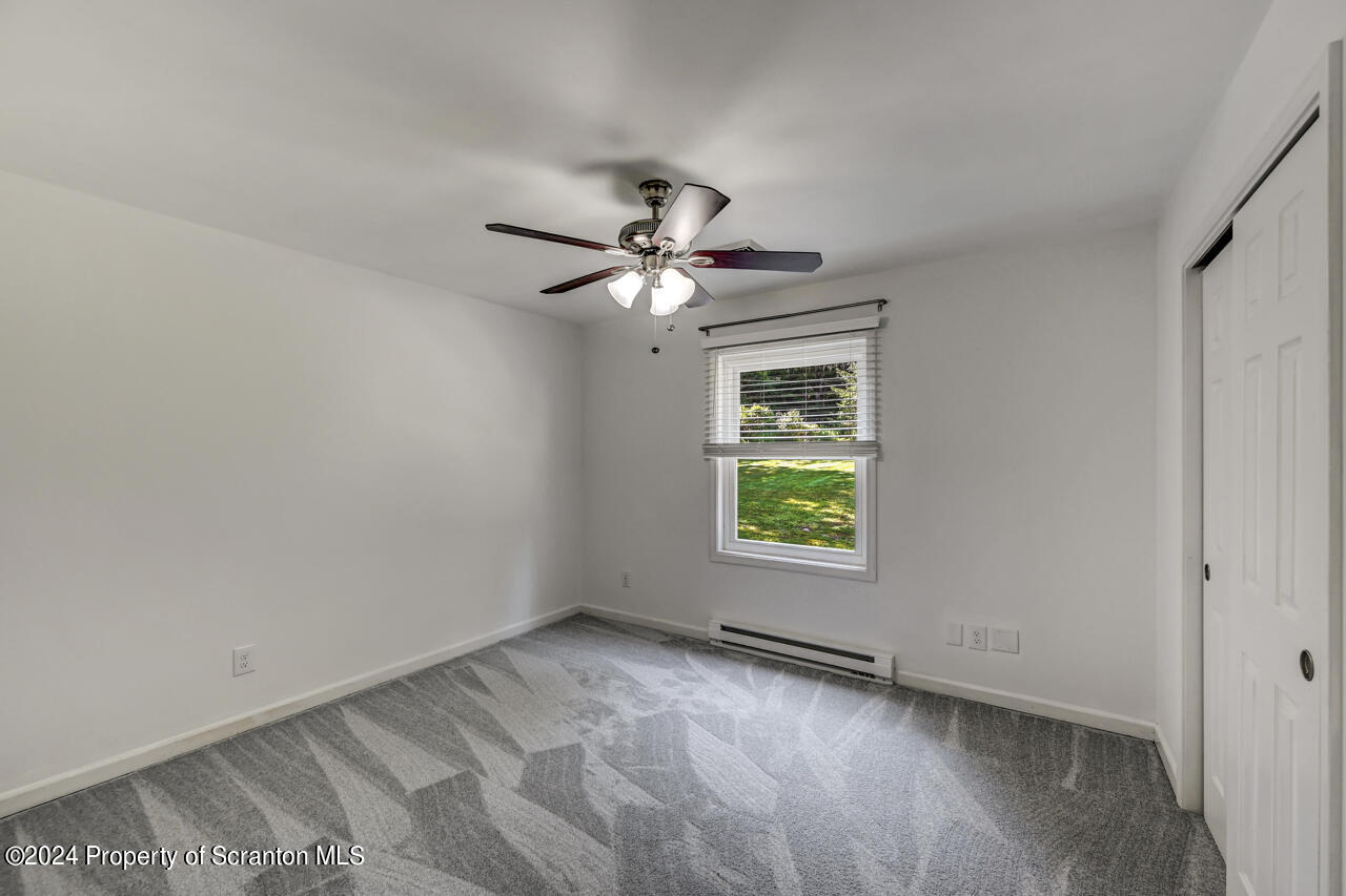 104 Bowens Road Moscow, PA 18444 - Photo 26 of 48 an empty room with a window and a fan