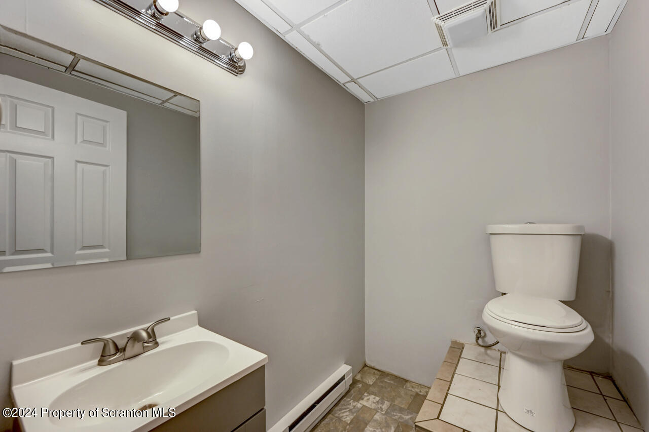 104 Bowens Road Moscow, PA 18444 - Photo 38 of 48 a bathroom with a sink toilet and a mirror