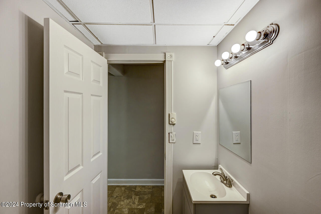 104 Bowens Road Moscow, PA 18444 - Photo 39 of 48 a bathroom with a sink a mirror and a shower
