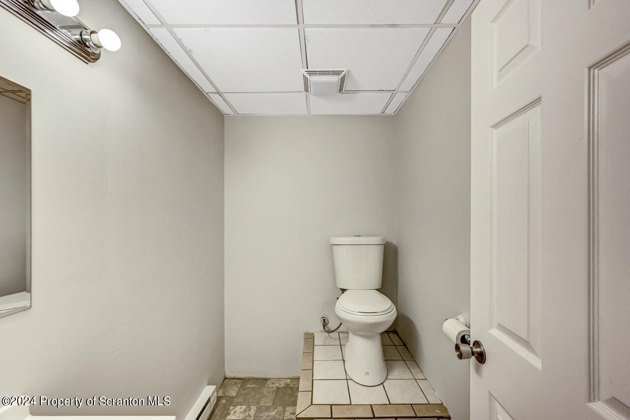 104 Bowens Road Moscow, PA 18444 - Photo 40 of 48 a bathroom with a toilet and a chandelier