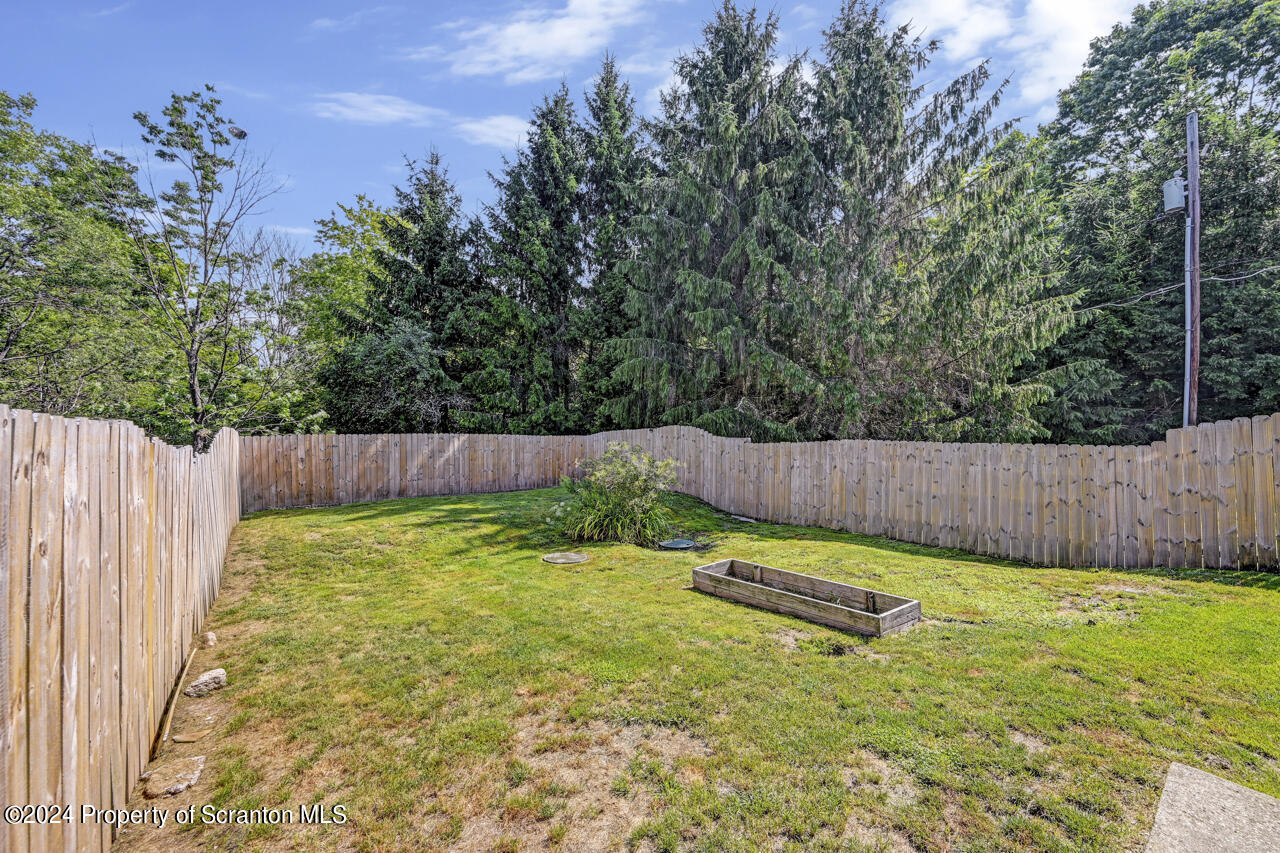 104 Bowens Road Moscow, PA 18444 - Photo 48 of 48 a backyard with a small yard and wooden fence
