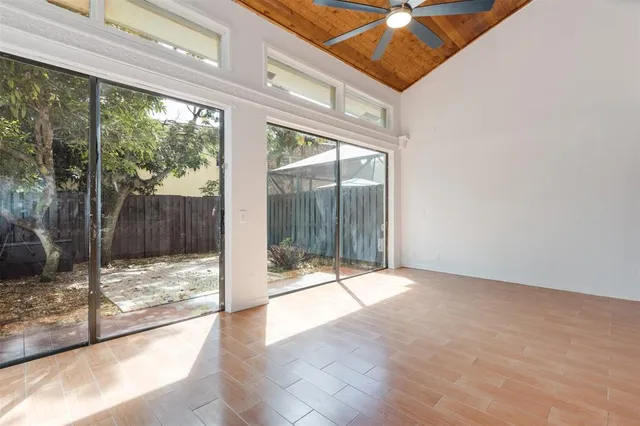a view of a room with wooden floor and windows