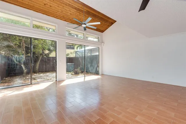 a view of a kitchen with furniture and wooden floor