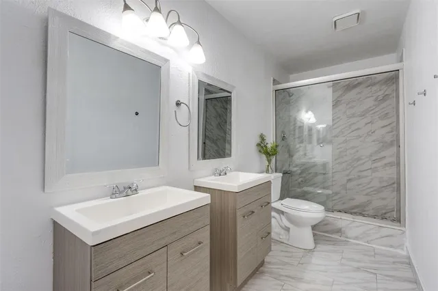 a bathroom with a sink a light fixture and a mirror