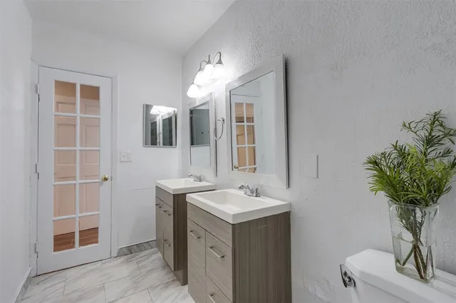a view of a hallway with wooden floor and entryway