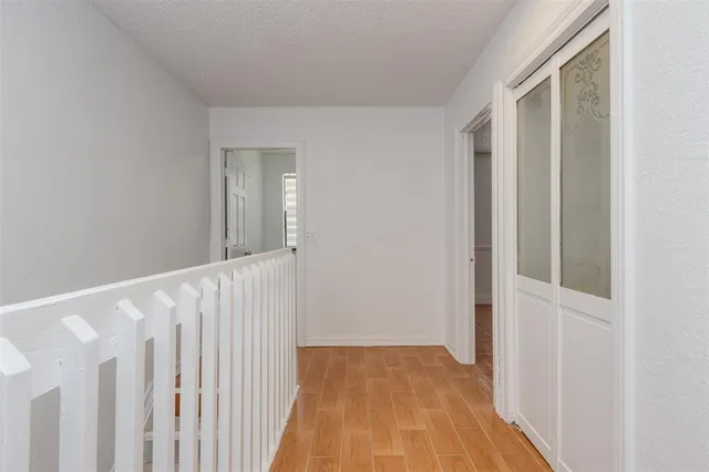 an empty room with a window and a ceiling fan