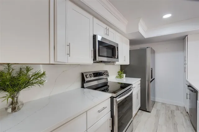 a kitchen with a sink a stove and refrigerator