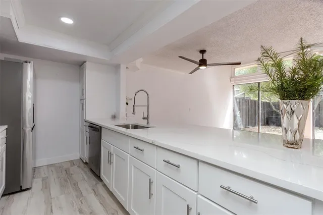 a kitchen with a sink and a refrigerator