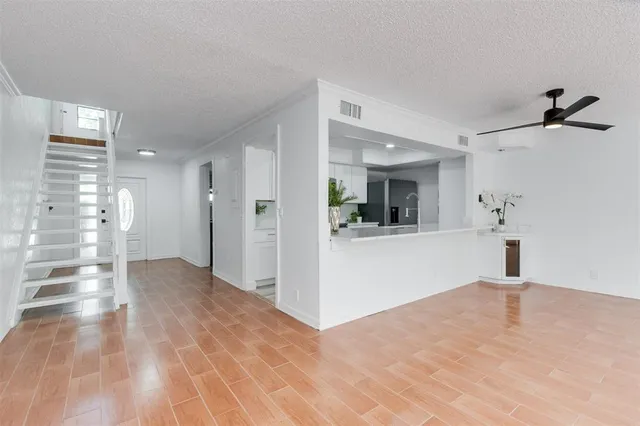 a view of a kitchen with a sink and a mirror