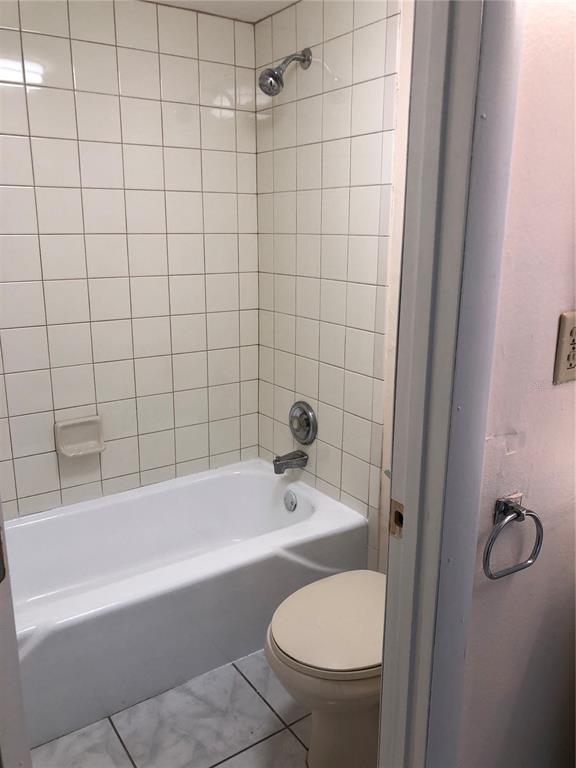 2616 Lemon Tree Lane, Unit F Orlando, FL 32839 - Photo 3 of 11 a bathroom with a granite countertop bathtub shower and toilet