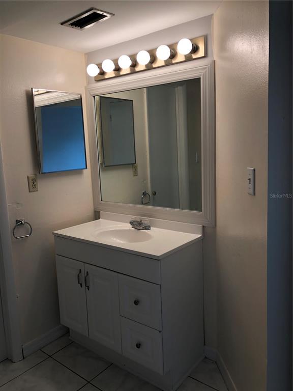 2616 Lemon Tree Lane, Unit F Orlando, FL 32839 - Photo 5 of 11 a bathroom with a sink and a mirror