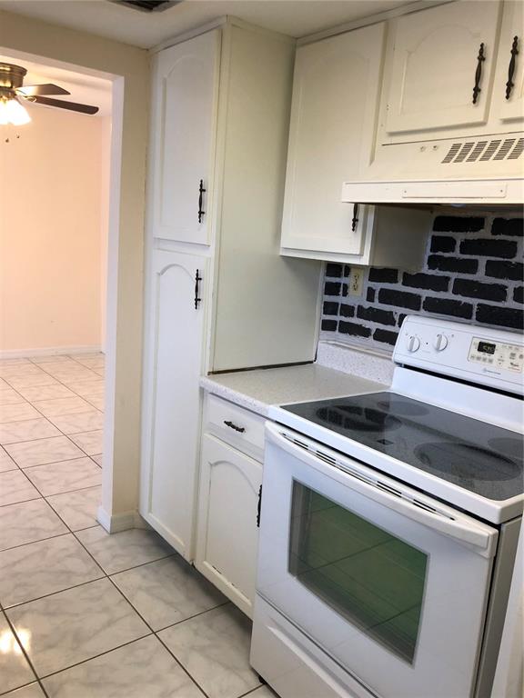 2616 Lemon Tree Lane, Unit F Orlando, FL 32839 - Photo 7 of 11 a kitchen with granite countertop a stove and a microwave
