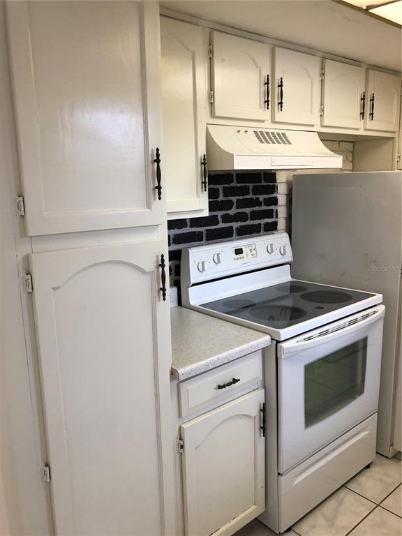 2616 Lemon Tree Lane, Unit F Orlando, FL 32839 - Photo 8 of 11 a view of stove top oven and cabinets