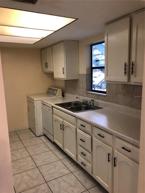 2616 Lemon Tree Lane, Unit F Orlando, FL 32839 - Photo 9 of 11 a kitchen with cabinets and window