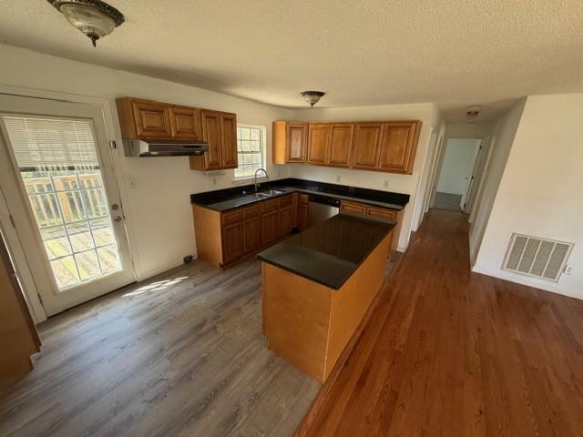 425 Chubbtown Road Cedartown, GA 30125 - Photo 13 of 29 a kitchen with granite countertop a refrigerator a sink dishwasher a stove and white countertops with wooden floor