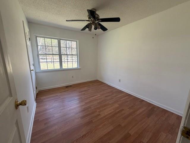 425 Chubbtown Road Cedartown, GA 30125 - Photo 24 of 29 an empty room with wooden floor fan and windows