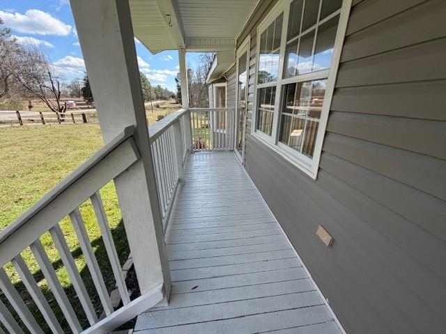 425 Chubbtown Road Cedartown, GA 30125 - Photo 4 of 29 a view of balcony with wooden floor and seating