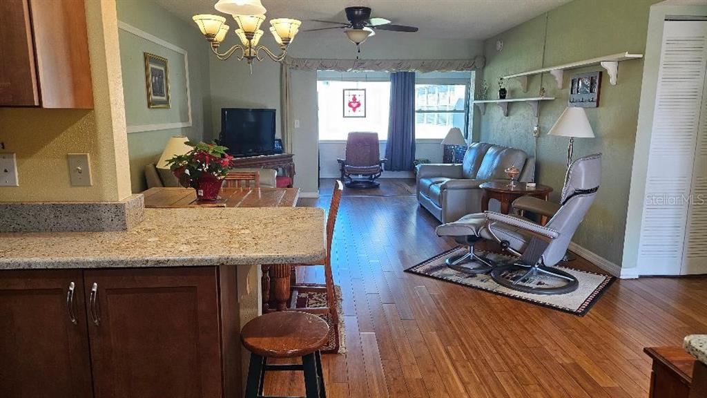 4600 98th Way North, Unit 210 St. Petersburg, FL 33708 - Photo 6 of 33 a living room with furniture and a flat screen tv