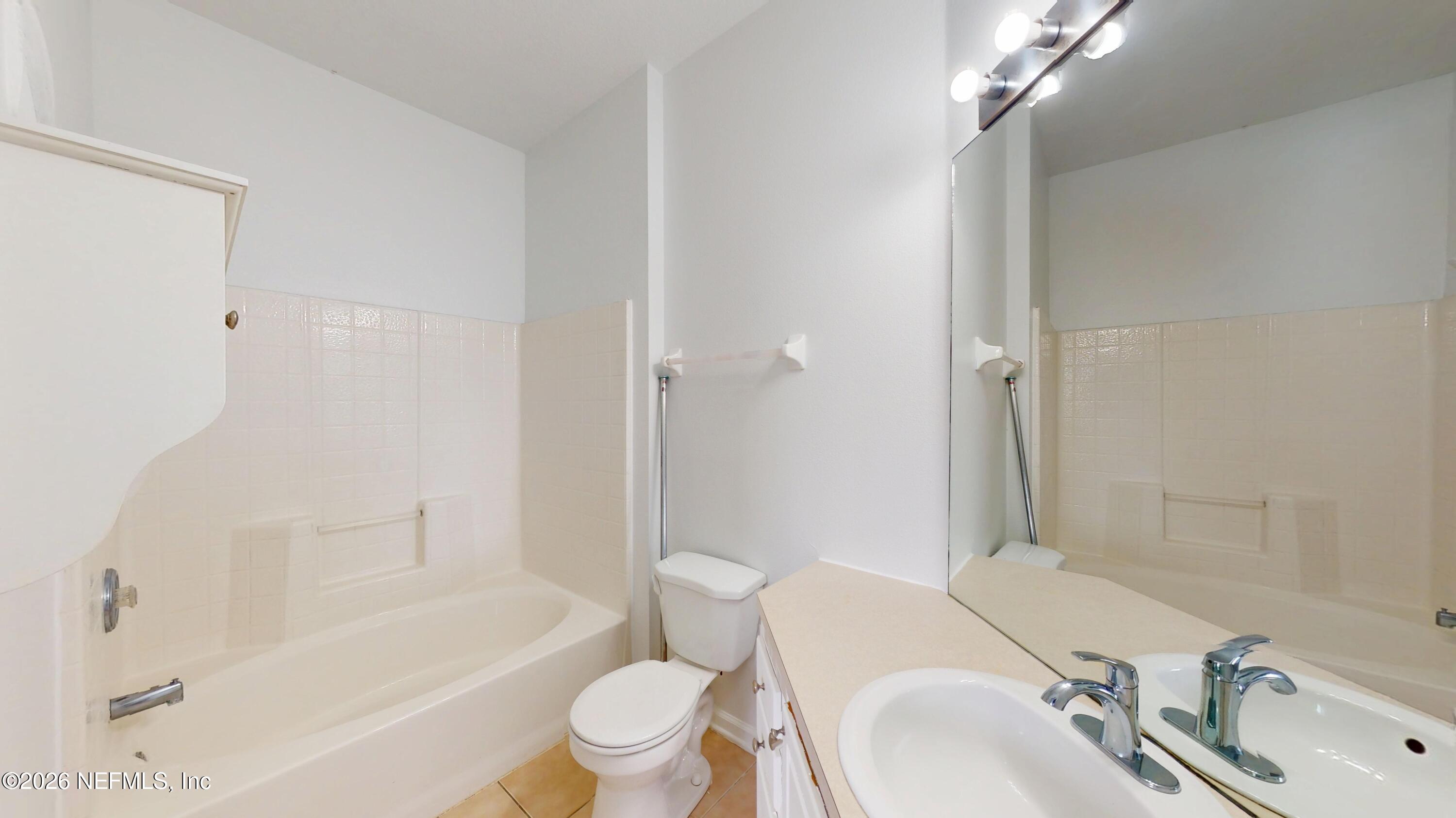 7990 Baymeadows Road East, Unit 912 Jacksonville, FL 32256 - Photo 13 of 25 a bathroom with a sink toilet and shower