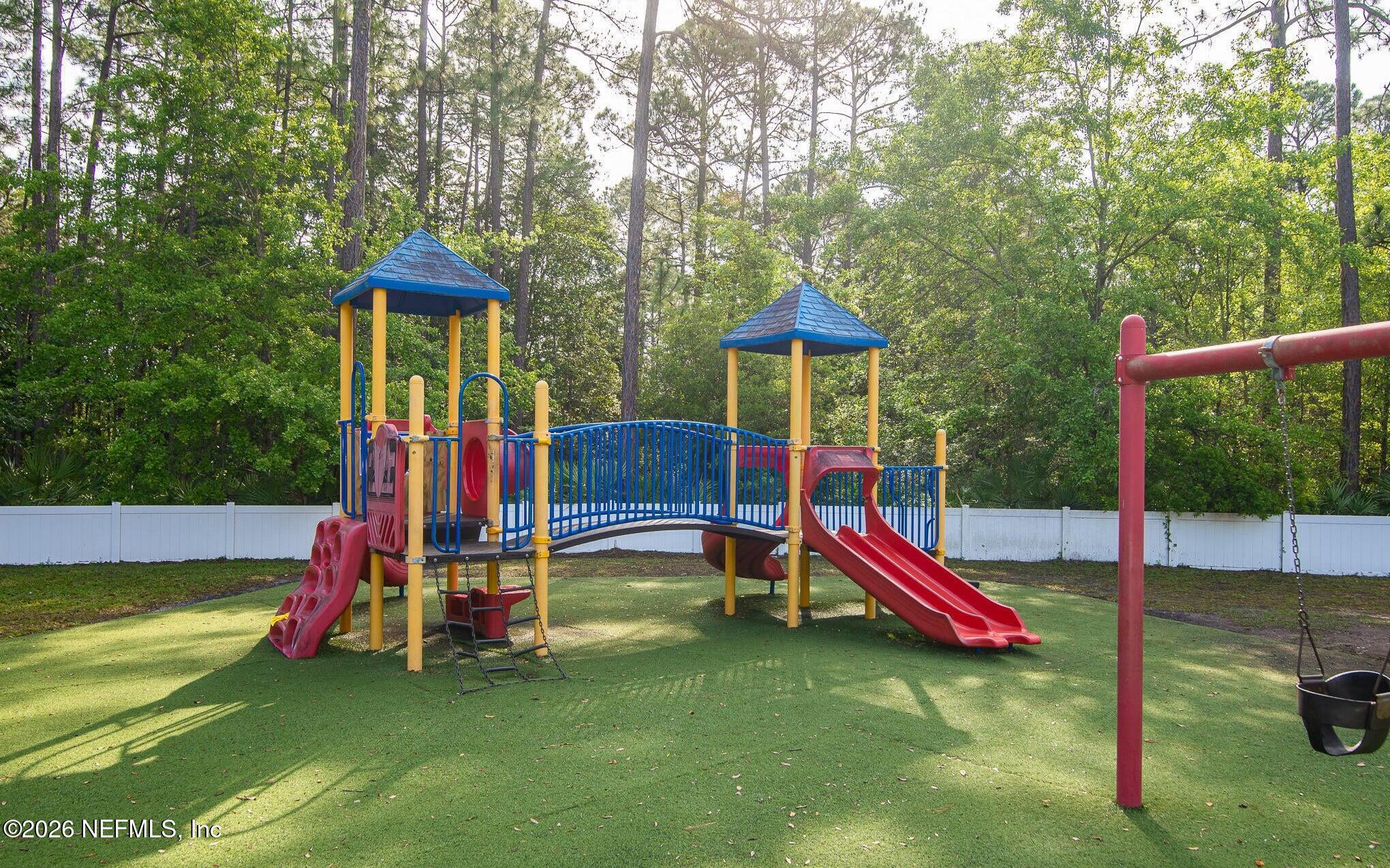 7990 Baymeadows Road East, Unit 912 Jacksonville, FL 32256 - Photo 24 of 25 a view of park with slide and a child swing