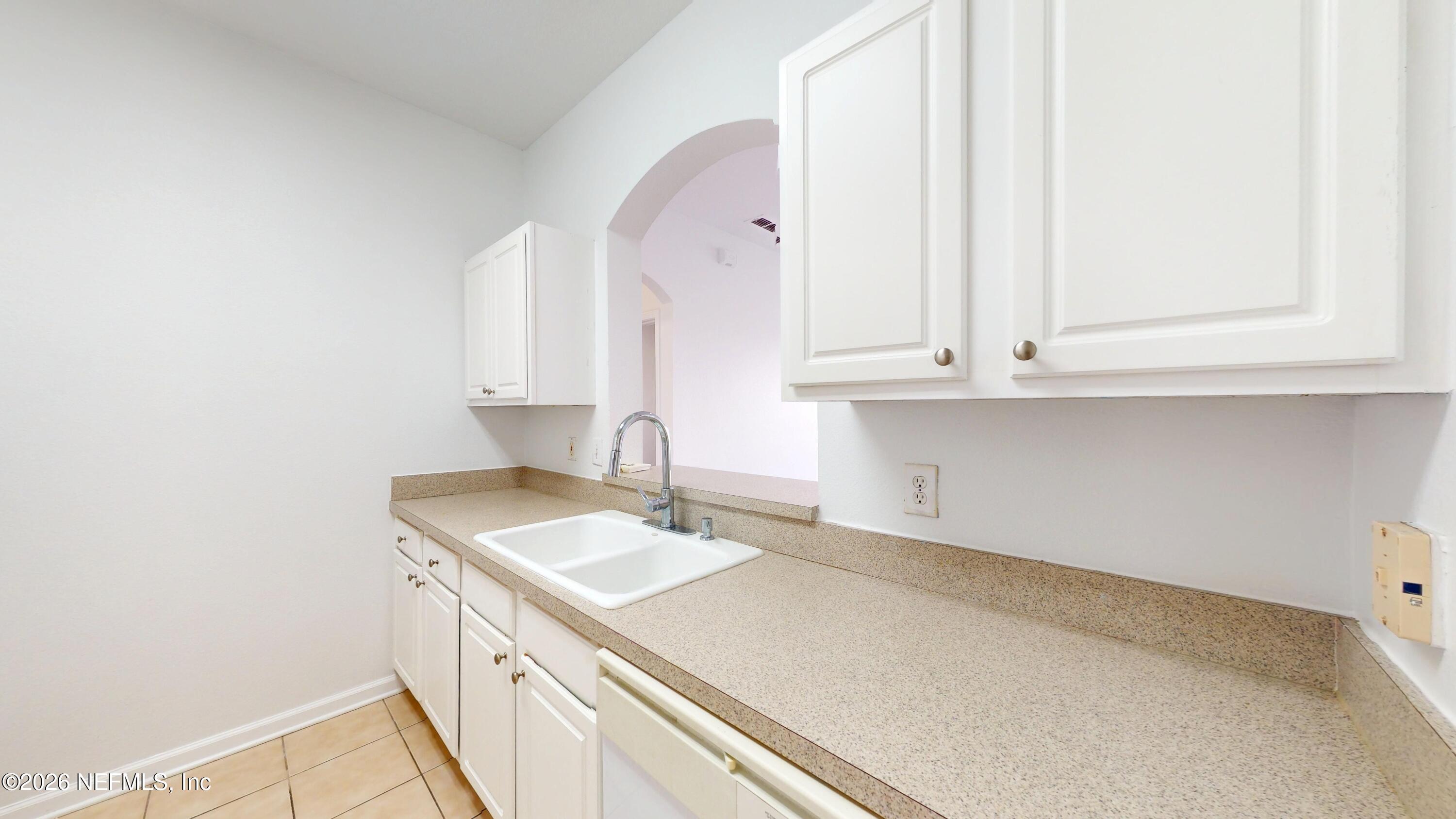 7990 Baymeadows Road East, Unit 912 Jacksonville, FL 32256 - Photo 7 of 25 a room with a sink and cabinets