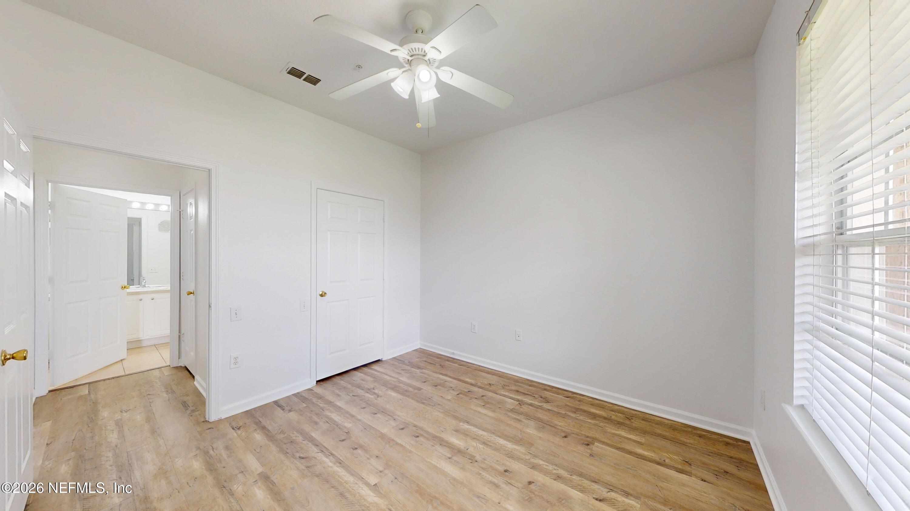 7990 Baymeadows Road East, Unit 912 Jacksonville, FL 32256 - Photo 10 of 25 wooden floor in an empty room with a window