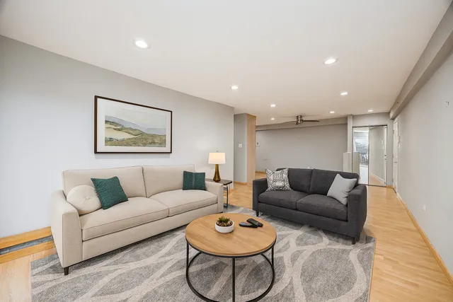 a living room with furniture and a wooden floor