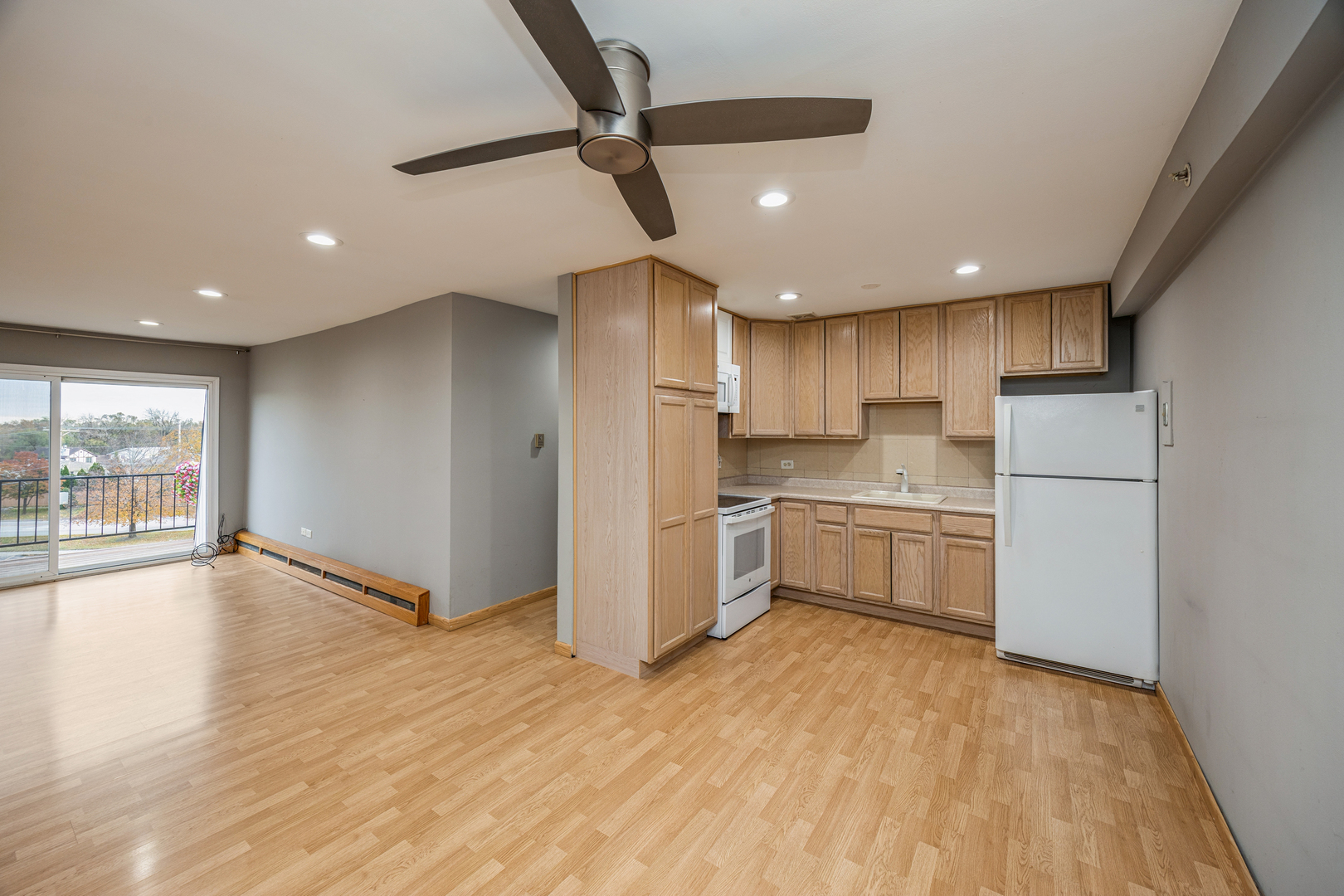 8480 West 103rd Terrace, Unit 301 Palos Hills, IL 60465 - Photo 7 of 17 a kitchen with a refrigerator and a sink