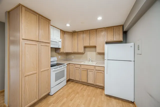 a kitchen with cabinets and stainless steel appliances