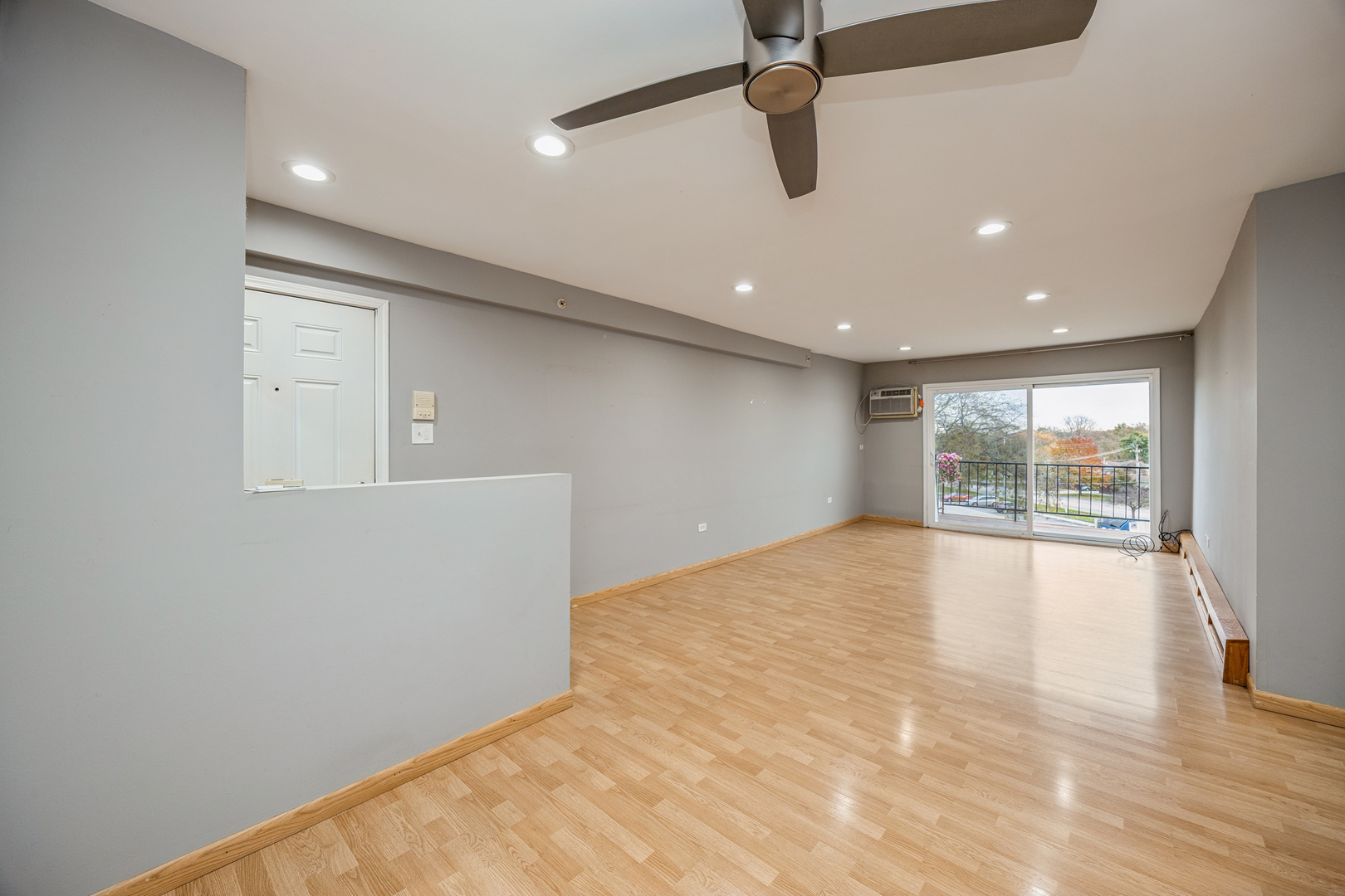 8480 West 103rd Terrace, Unit 301 Palos Hills, IL 60465 - Photo 9 of 17 an empty room with wooden floor and windows