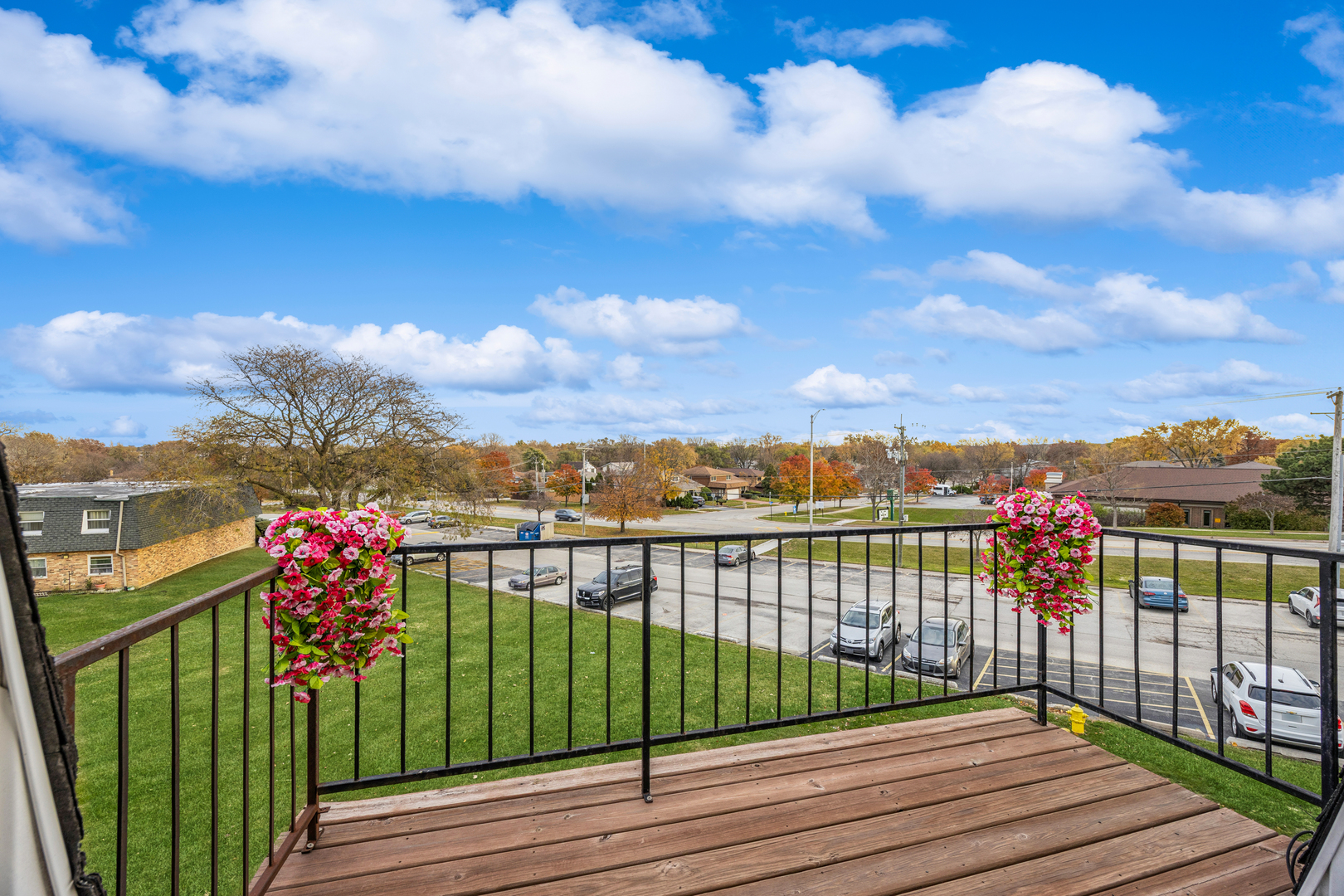 8480 West 103rd Terrace, Unit 301 Palos Hills, IL 60465 - Photo 10 of 17 a view of a balcony with wooden floor & fence
