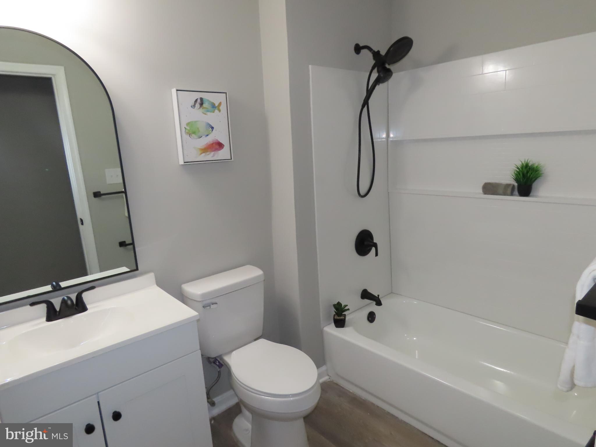 563 Principio Road Port Deposit, MD 21904 - Photo 11 of 16 a bathroom with a toilet and a tub