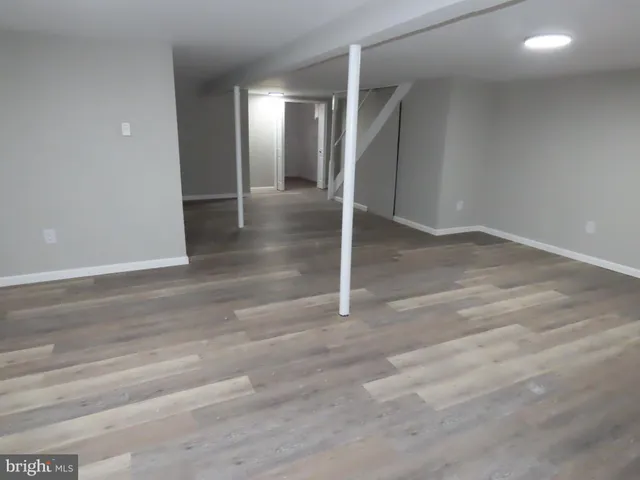 an empty room with wooden floor