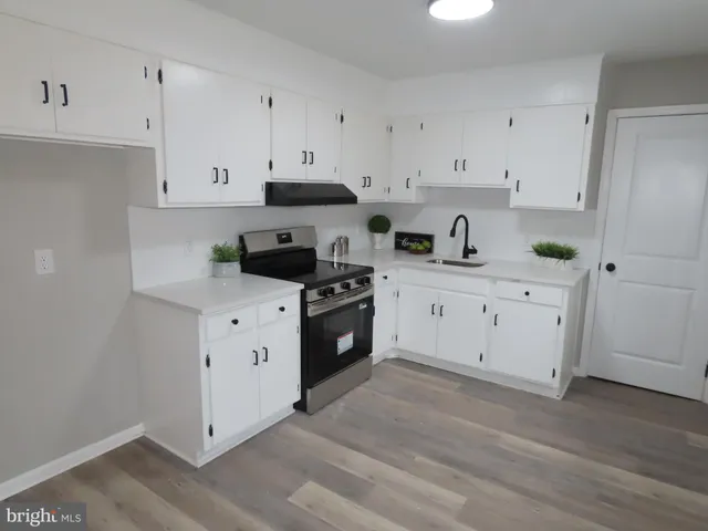 a kitchen with white cabinets and white appliances