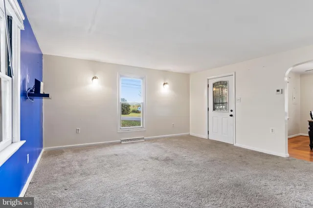 an empty room with windows and closet