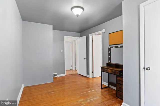 a big room with wooden floor and furniture